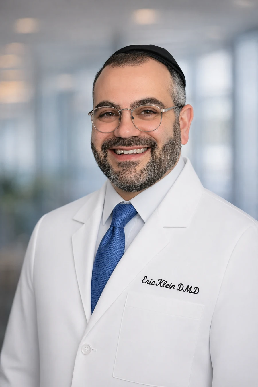 Dr. Eric Klein, D.M.D. in a white clinical coat